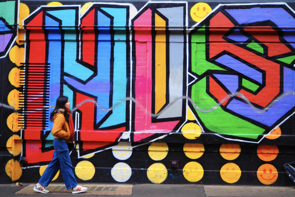 Walking Past Vibrant Street Art Mural